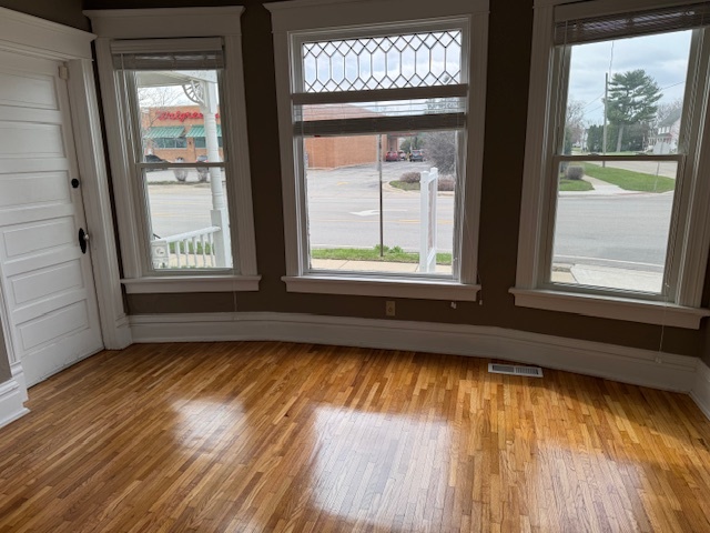 43 West Church Street, Unit 100 Sandwich, IL 60548 - Photo 2 of 22 a view of an empty room with wooden floor and a window