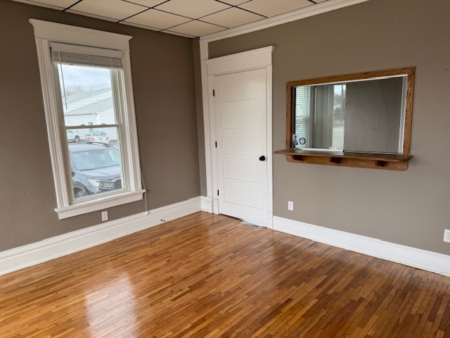 43 West Church Street, Unit 100 Sandwich, IL 60548 - Photo 3 of 22 a view of an empty room with wooden floor and a window
