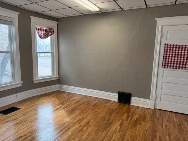 43 West Church Street, Unit 100 Sandwich, IL 60548 - Photo 6 of 22 a view of an empty room with wooden floor and a window