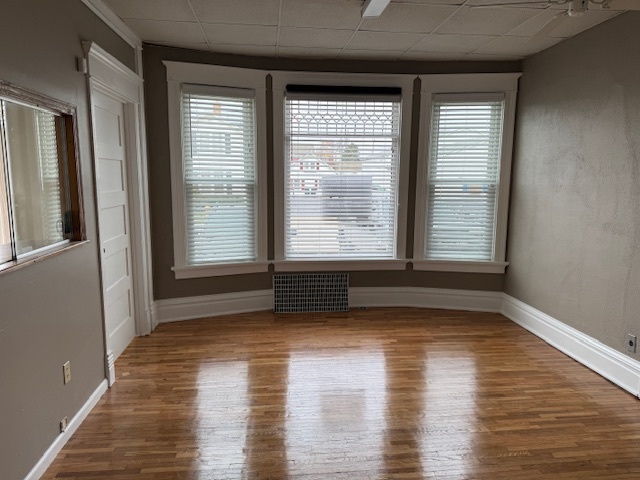 43 West Church Street, Unit 100 Sandwich, IL 60548 - Photo 8 of 22 a view of an empty room with wooden floor and a window