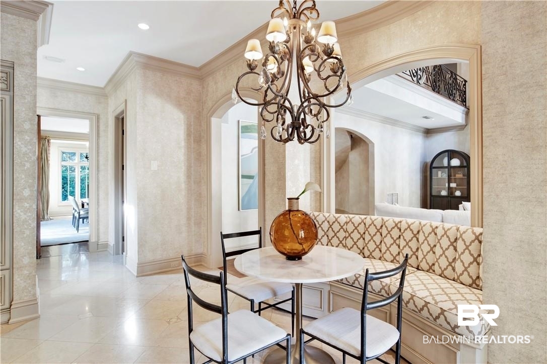 4 Chancery Court Mobile, AL 36608 - Photo 16 of 54 Dining space featuring a chandelier and crown molding