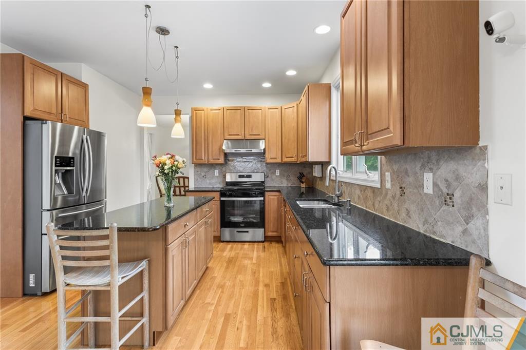 104 Mundy Avenue Edison, NJ 08820 - Photo 15 of 55 a kitchen with stainless steel appliances granite countertop a refrigerator a sink dishwasher a stove and a microwave oven on granite countertops