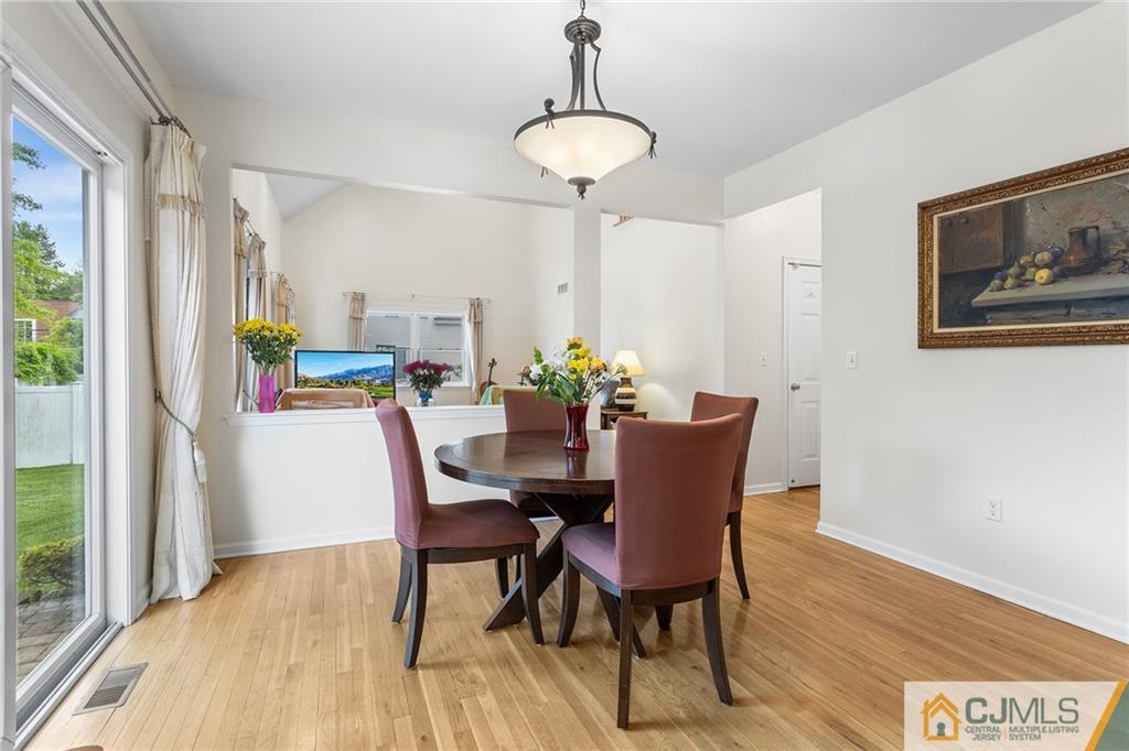 104 Mundy Avenue Edison, NJ 08820 - Photo 16 of 55 a dining room with furniture a window and wooden floor
