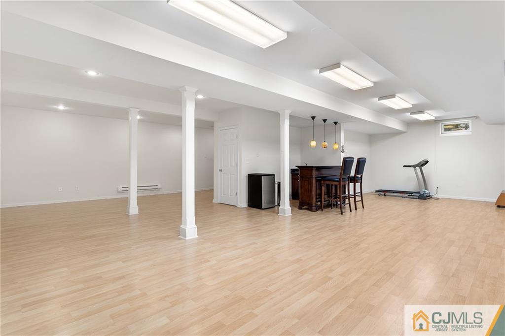 104 Mundy Avenue Edison, NJ 08820 - Photo 38 of 55 a view of a kitchen with a dining table chairs and wooden floor