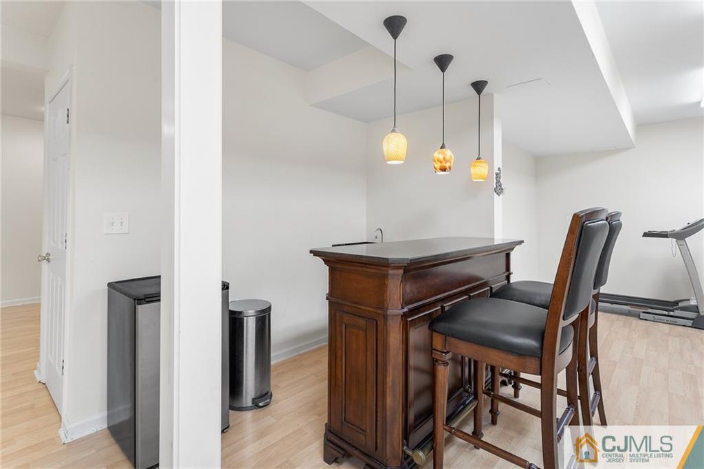 104 Mundy Avenue Edison, NJ 08820 - Photo 39 of 55 a view of a hallway with furniture and a wooden floor