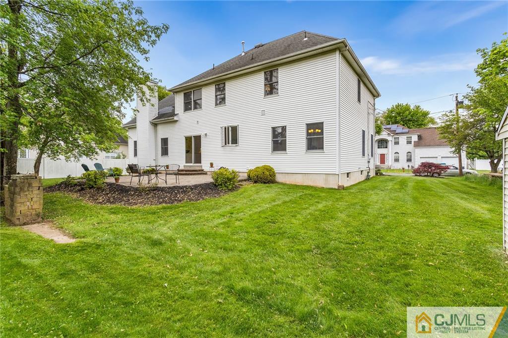 104 Mundy Avenue Edison, NJ 08820 - Photo 43 of 55 a view of a white house with a big yard and large trees