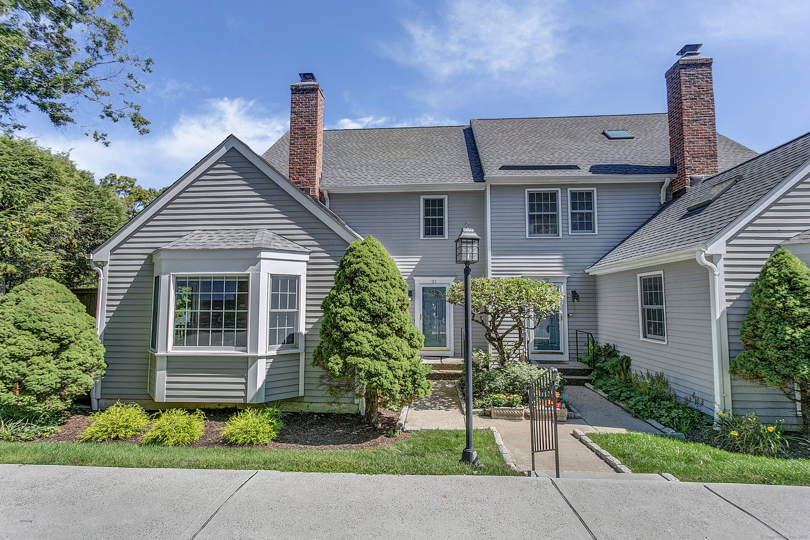 a front view of a house with a garden