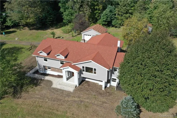 an aerial view of a house with swimming pool and garden