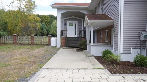 a view of a field with trees in the background