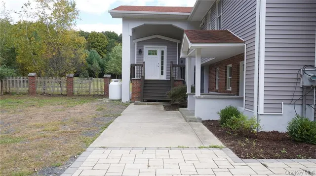 a view of a field with trees in the background
