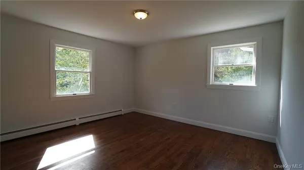 a view of an empty room and a window