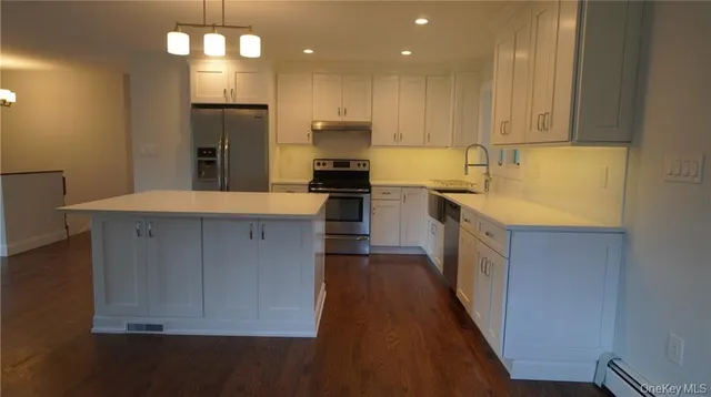 a kitchen with stainless steel appliances granite countertop a refrigerator and a sink