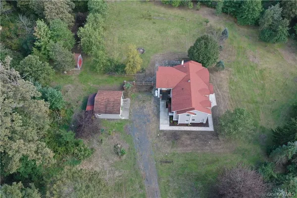 an aerial view of a house with outdoor space and street view