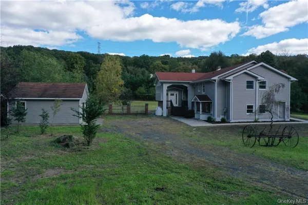 a view of a house with backyard sitting area and garden