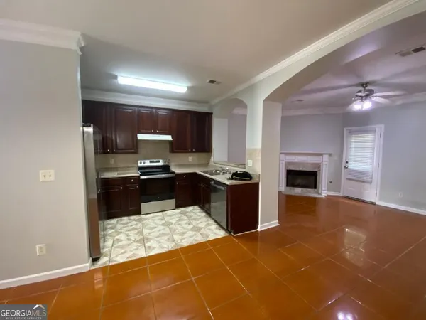a large kitchen with kitchen island granite countertop a stove a sink and a microwave