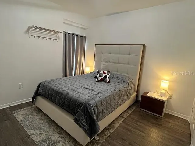 a bed sitting in a bedroom next to a window