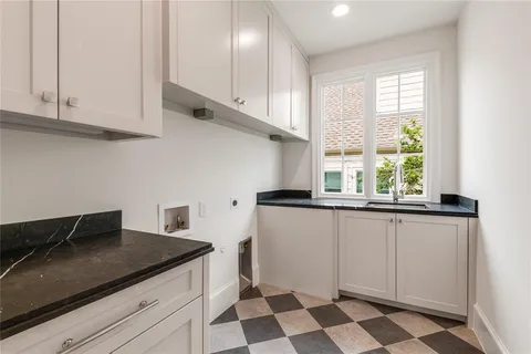 a kitchen with stainless steel appliances granite countertop a sink and a stove