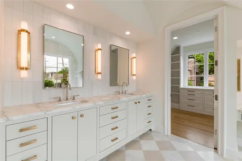 a bathroom with double vanity sink and a mirror