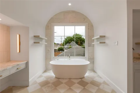 a spacious bathroom with a bathtub and shower