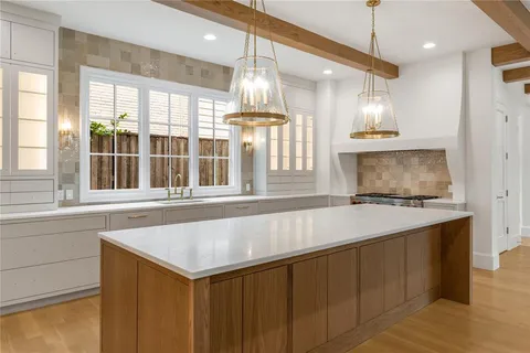 a kitchen with a stove a sink and a refrigerator