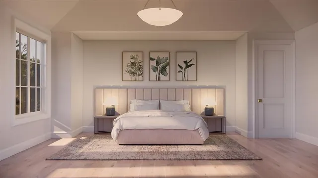 a bedroom with a bed and painting on the wall