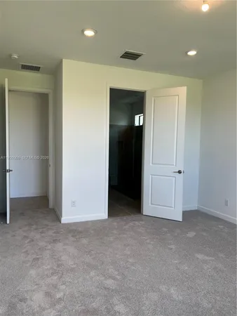 a bathroom with a granite countertop sink double and mirror