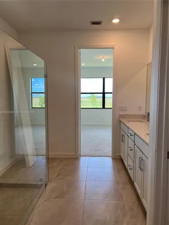 a kitchen with stainless steel appliances granite countertop grey cabinets a stove a sink and dishwasher