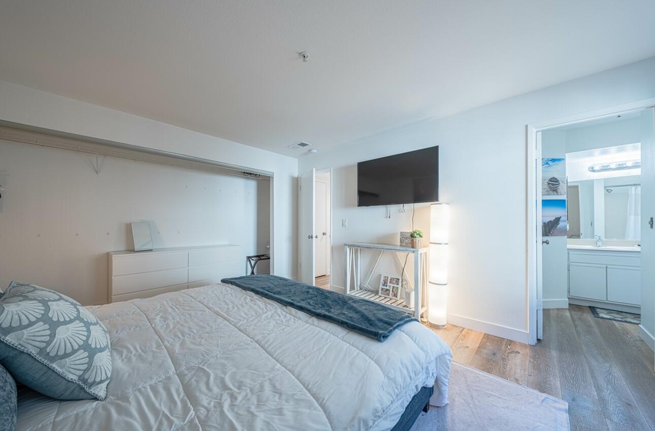 640 Pheasant Ridge Road Monterey, CA 93940 - Photo 13 of 27 a bedroom with a bed and a flat screen tv