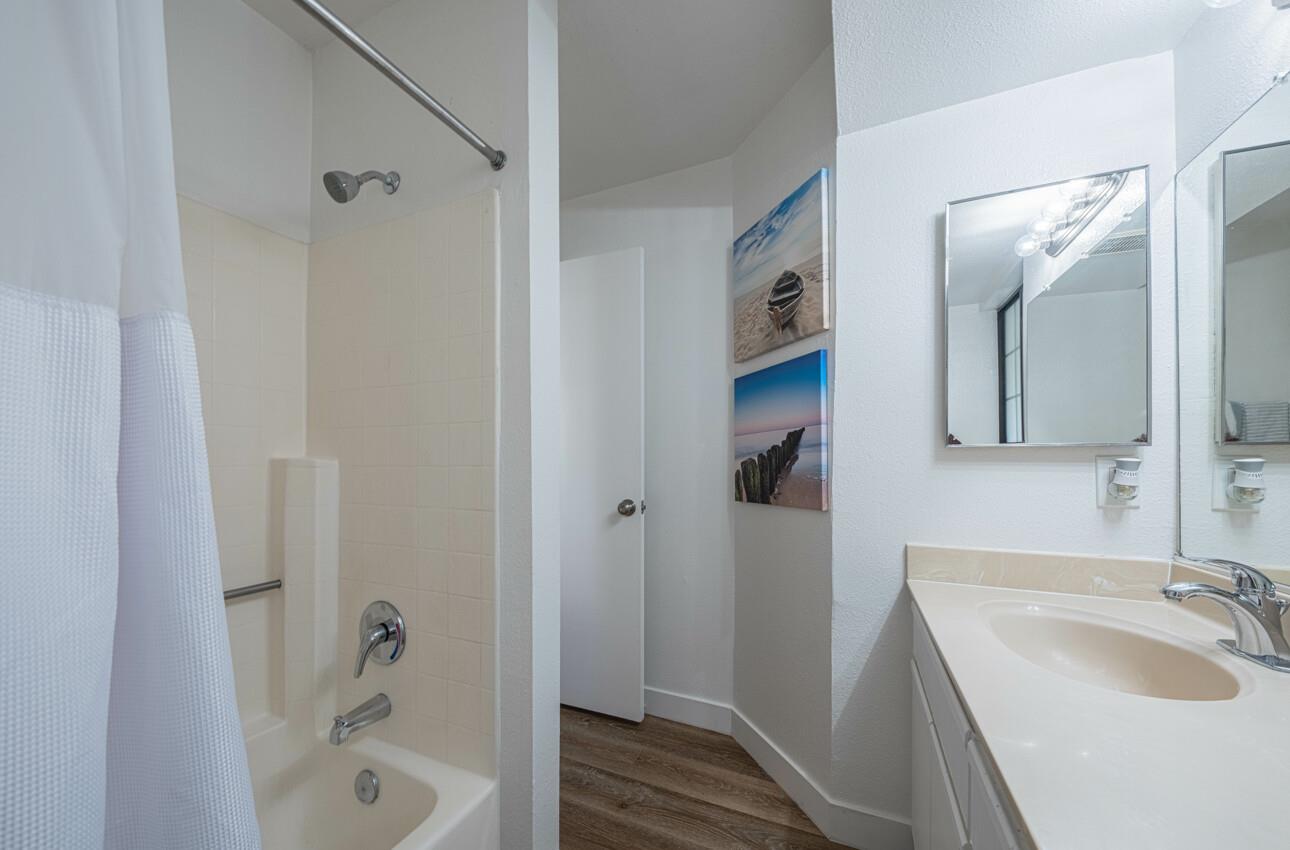 640 Pheasant Ridge Road Monterey, CA 93940 - Photo 15 of 27 a bathroom with a tub sink vanity granite and shower
