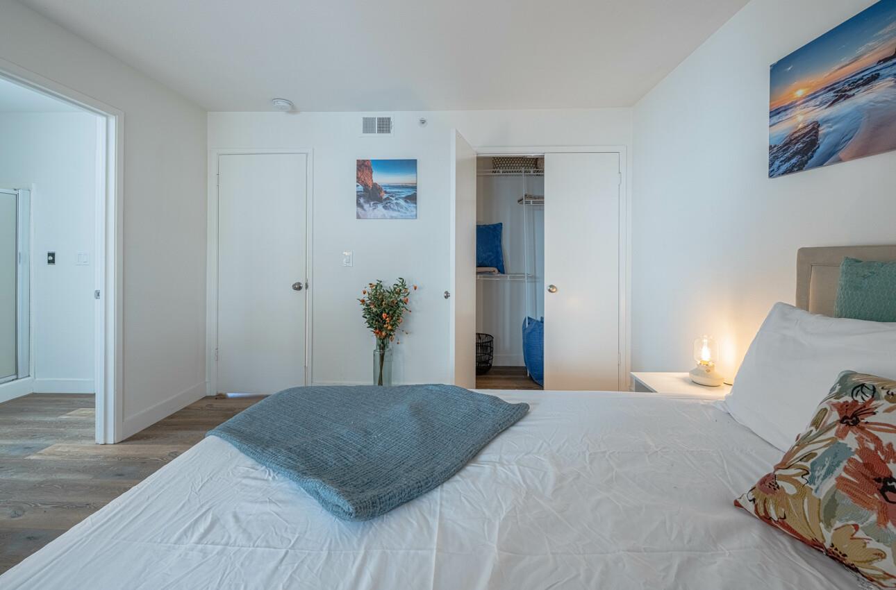 640 Pheasant Ridge Road Monterey, CA 93940 - Photo 17 of 27 a bedroom with a bed and painting on the wall
