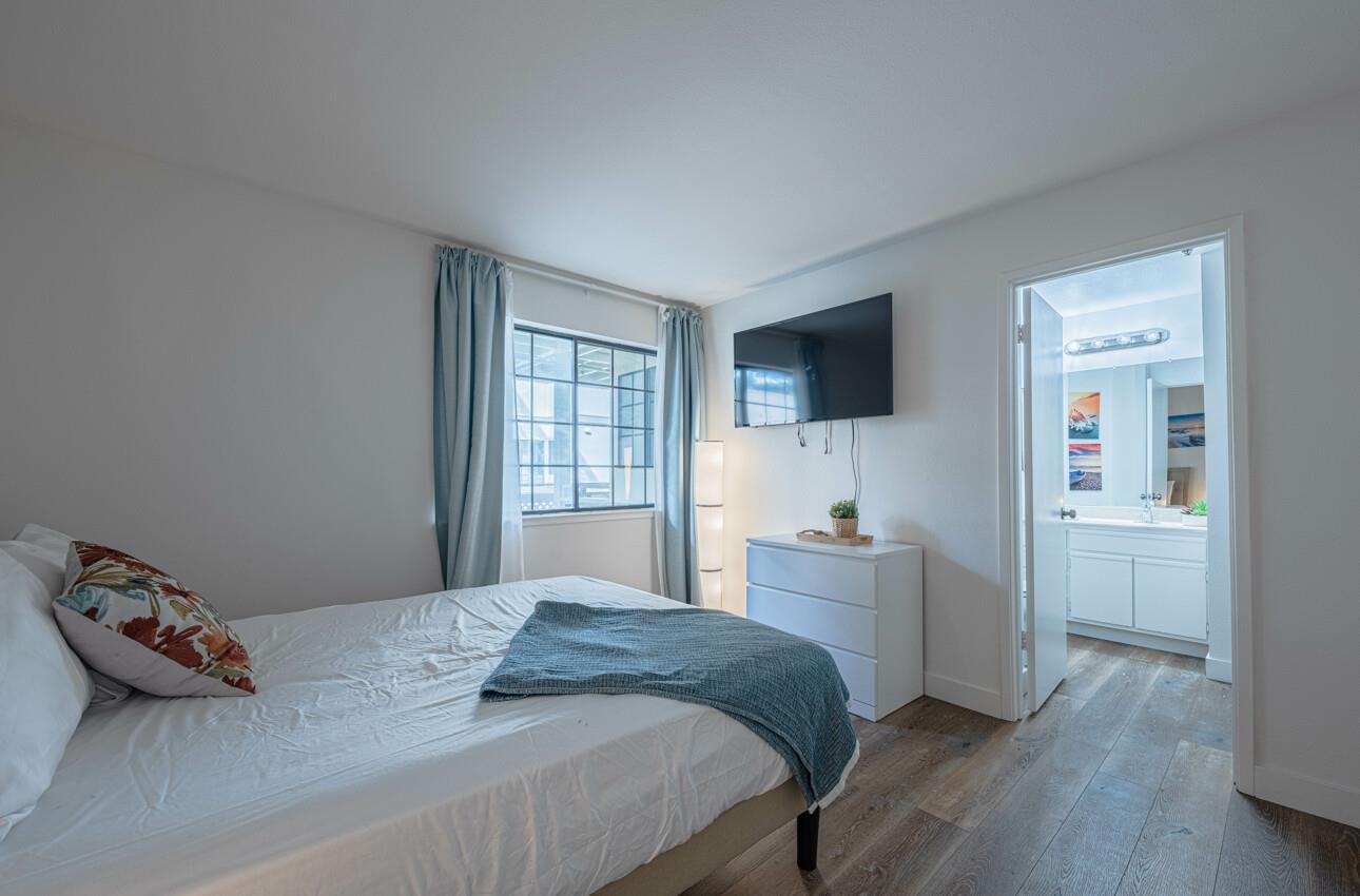 640 Pheasant Ridge Road Monterey, CA 93940 - Photo 18 of 27 a bedroom with a bed and a flat screen tv