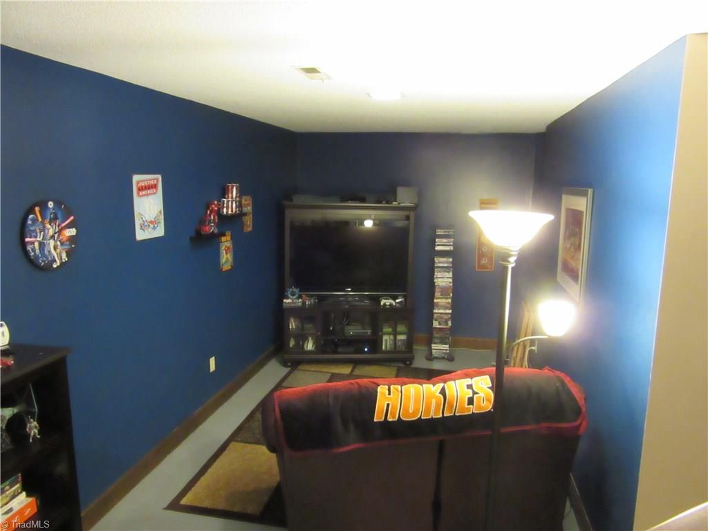 157 Old Farm Road Thomasville, NC 27360 - Photo 17 of 30 This basement den space completes the in-law suite scenario or it could be a great "man cave" or game room! The possibilities are endless!