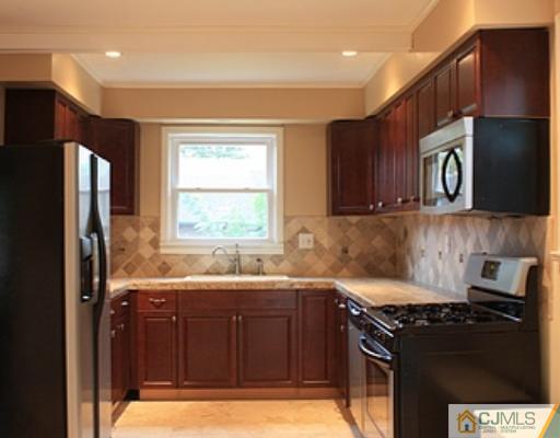110 Parker Street Middlesex, NJ 08846 - Photo 3 of 8 a kitchen with a sink stove top oven and refrigerator