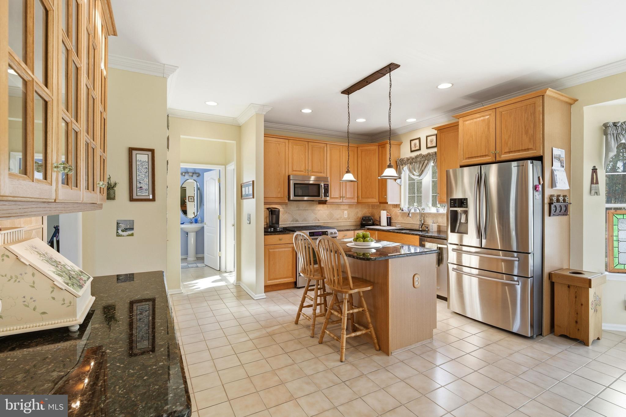 27 Rodeo Drive West Creek, NJ 08092 - Photo 14 of 52 a kitchen with stainless steel appliances a refrigerator a stove a sink a dining table and chairs