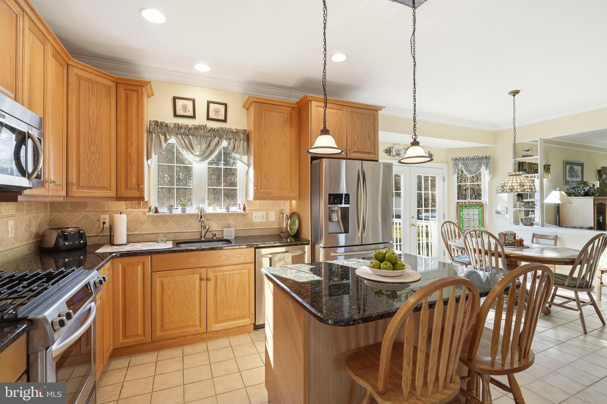 27 Rodeo Drive West Creek, NJ 08092 - Photo 18 of 52 a kitchen with stainless steel appliances a sink a stove a table and chairs