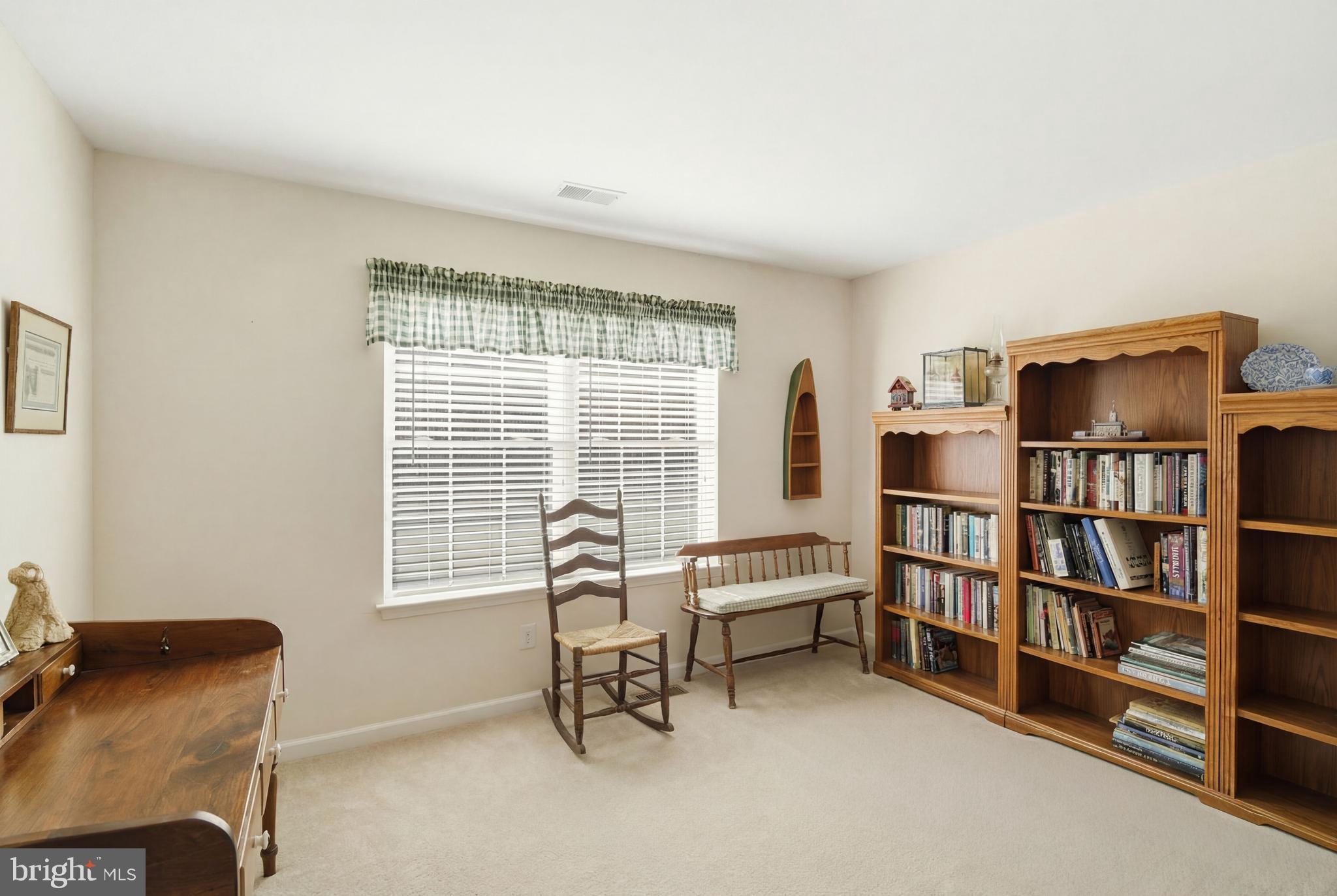 27 Rodeo Drive West Creek, NJ 08092 - Photo 33 of 52 a living room with furniture a bookshelf and a window