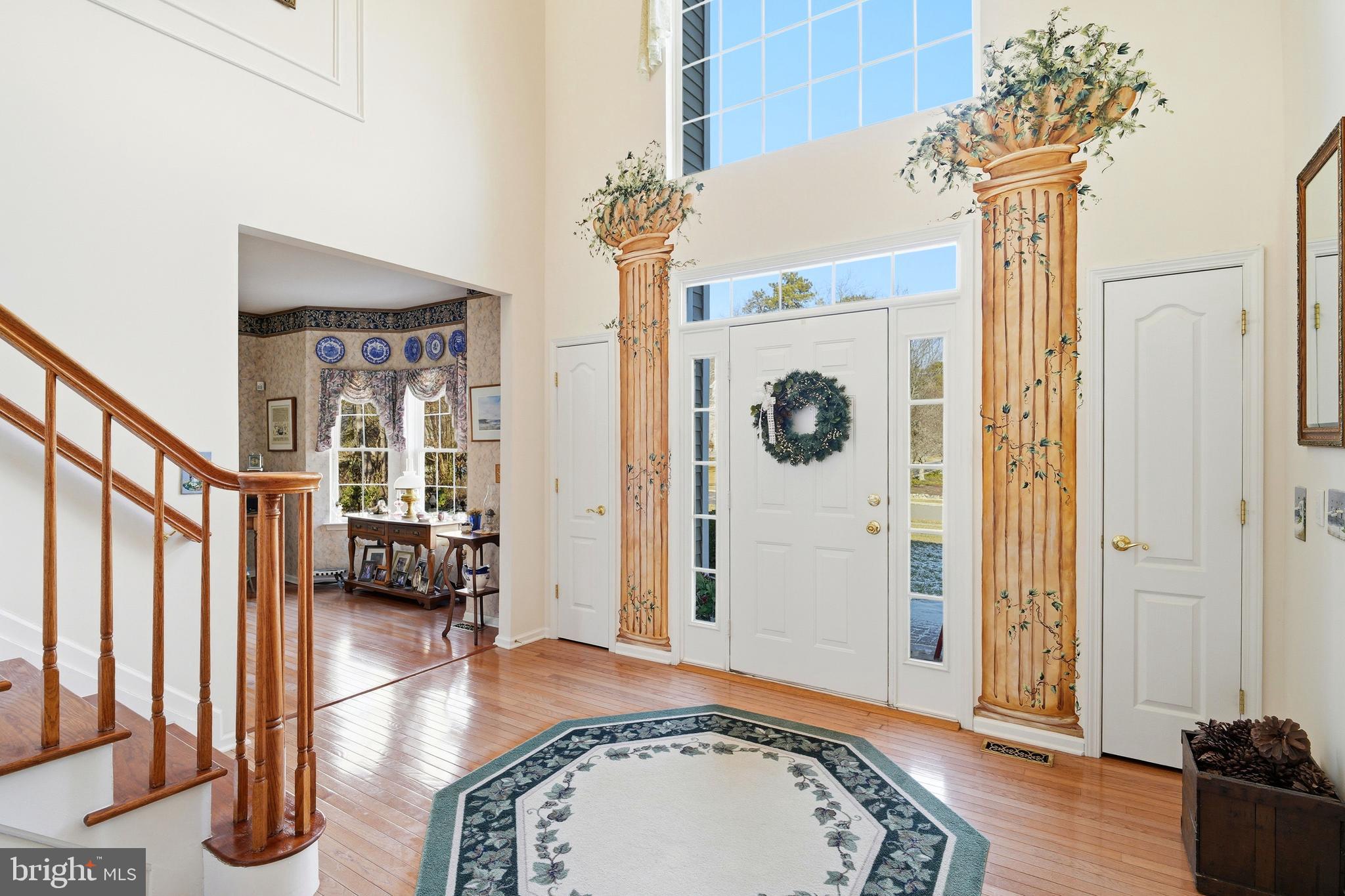 27 Rodeo Drive West Creek, NJ 08092 - Photo 7 of 52 a view of a hallway with wooden floor and a chandelier