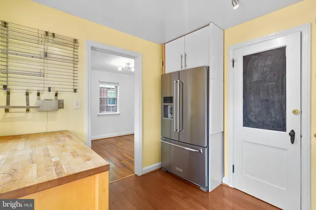 a kitchen with stainless steel appliances granite countertop a refrigerator and a stove