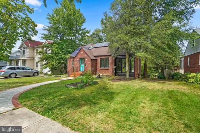 a backyard of a house with a yard and swing