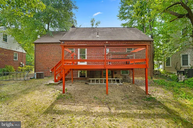 a view of a house with a yard and sitting area