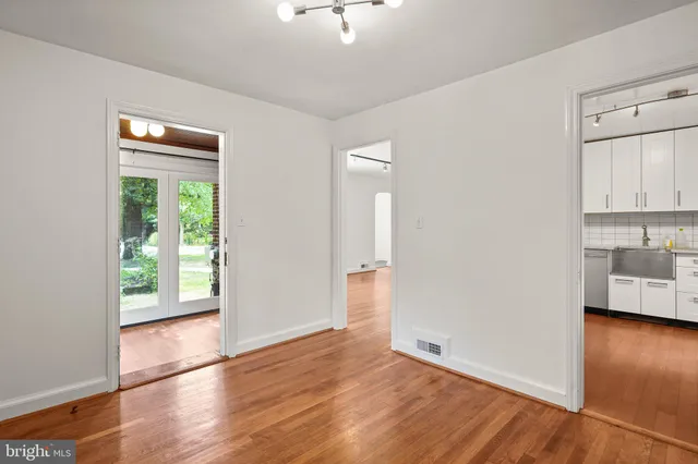 a view of a room with wooden floor and a window