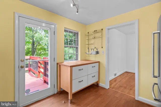 a view of a bedroom with wooden floor and cabinet