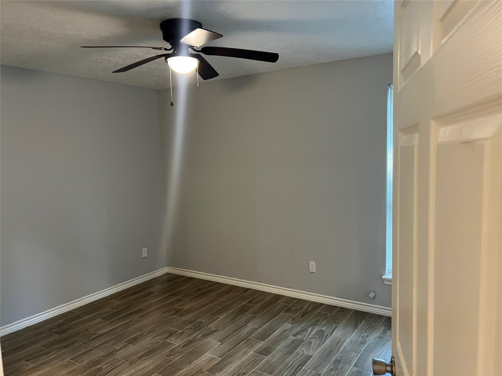 2375 Virginia Court, Unit B Montgomery, TX 77316 - Photo 12 of 13 a view of an empty room with wooden floor