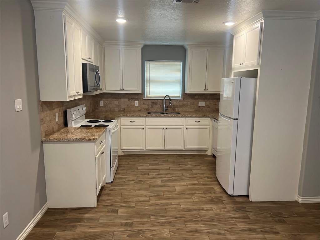 2375 Virginia Court, Unit B Montgomery, TX 77316 - Photo 3 of 13 a kitchen with stainless steel appliances granite countertop a stove a sink and a refrigerator