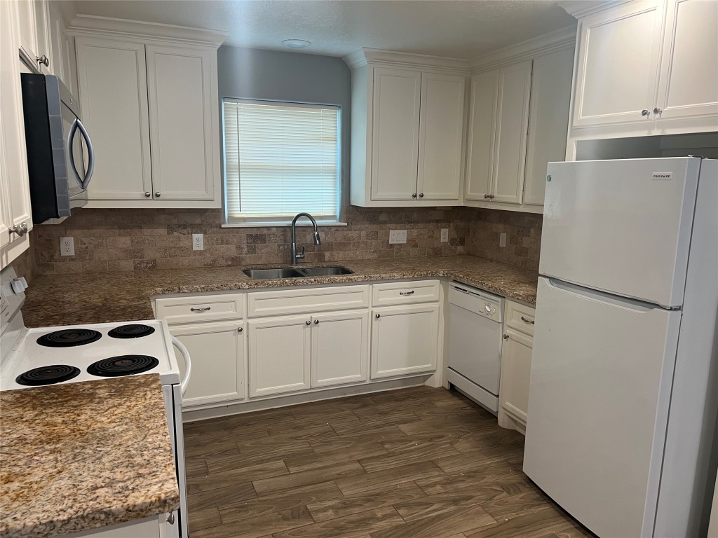 2375 Virginia Court, Unit B Montgomery, TX 77316 - Photo 4 of 13 a kitchen with a sink a refrigerator and cabinets
