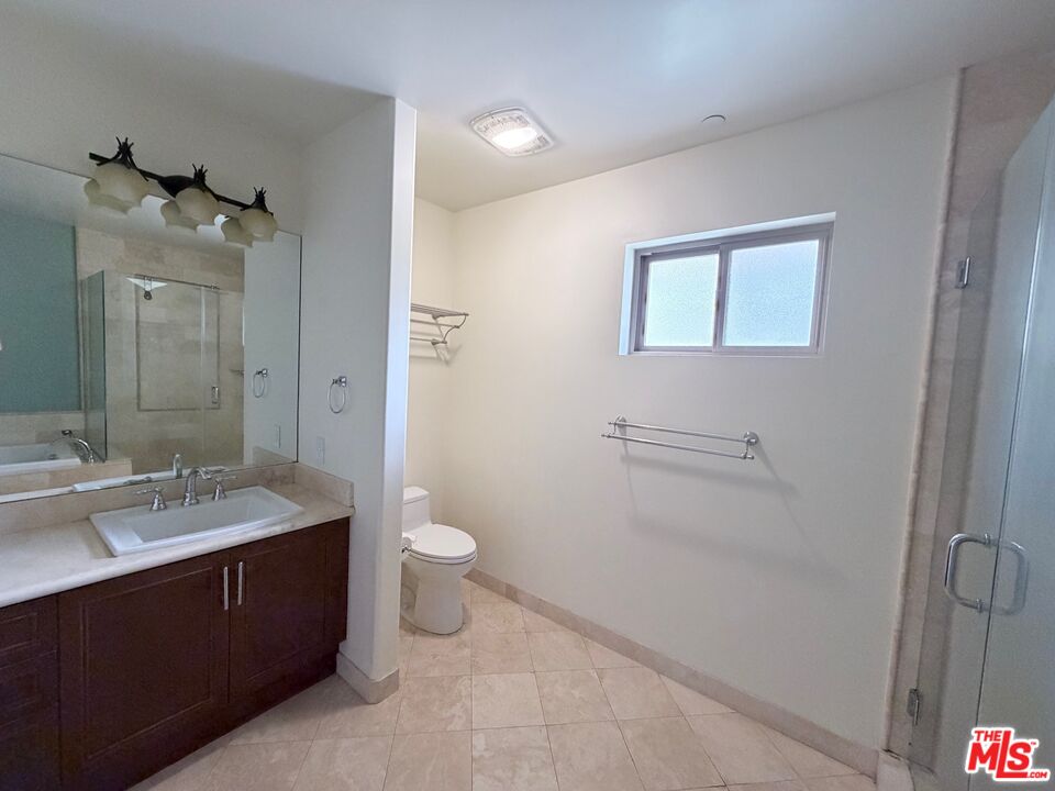 8238 West Manchester Avenue, Unit 308 Playa del Rey, CA 90293 - Photo 12 of 19 a bathroom with a double vanity sink toilet and mirror