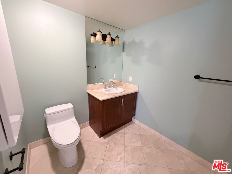 8238 West Manchester Avenue, Unit 308 Playa del Rey, CA 90293 - Photo 13 of 19 a bathroom with a toilet sink and mirror