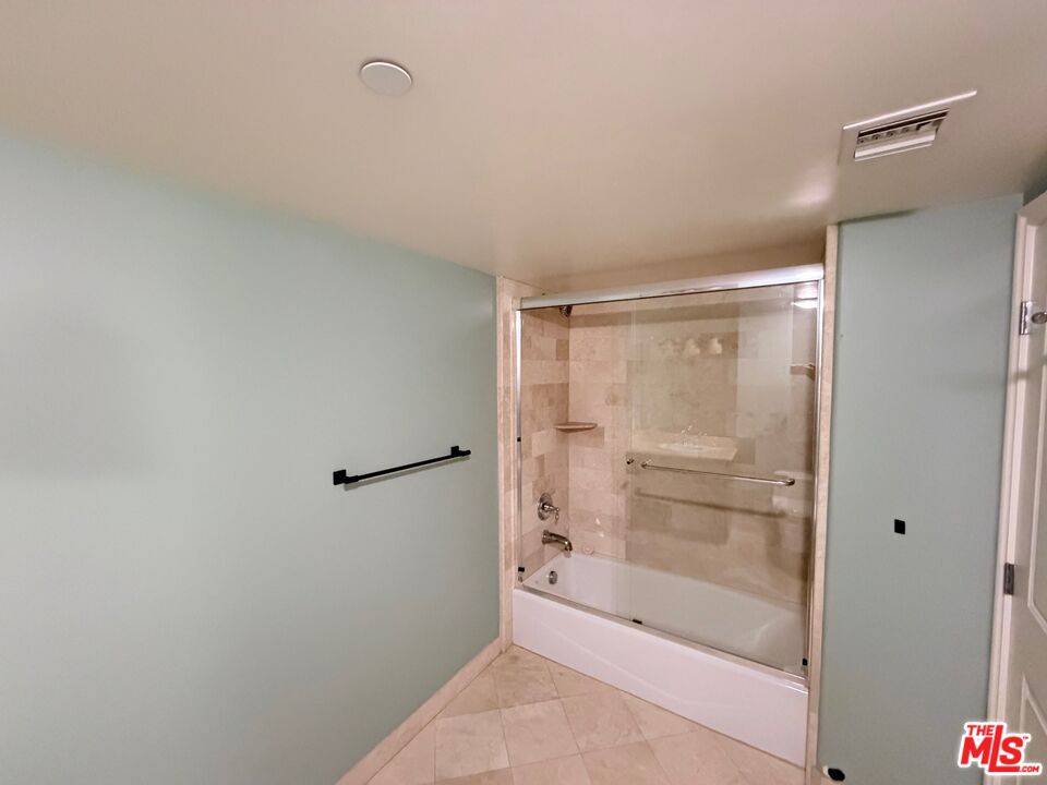 8238 West Manchester Avenue, Unit 308 Playa del Rey, CA 90293 - Photo 14 of 19 a bathroom with a glass shower door