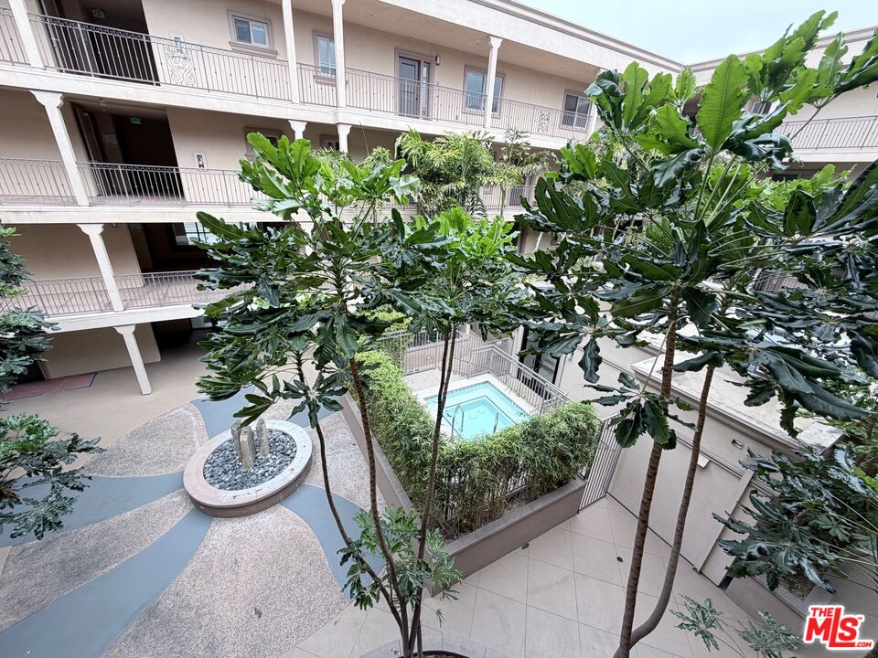 8238 West Manchester Avenue, Unit 308 Playa del Rey, CA 90293 - Photo 17 of 19 a view of a backyard with chair and potted plants