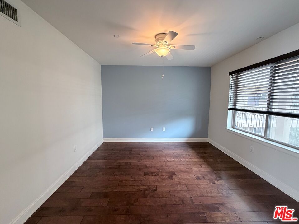 8238 West Manchester Avenue, Unit 308 Playa del Rey, CA 90293 - Photo 2 of 19 an empty room with windows and chandelier fan